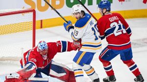 Montreal Canadiens goaltender Jakub Dobes deflects the puck away from Buffalo Sabres' Peyton Krebs as Canadiens' Kaiden Kuhle defends during first period, second round, game 4, NHL playoff action in Montreal on Tuesday, May 12, 2026. (Graham Hughes/CP)