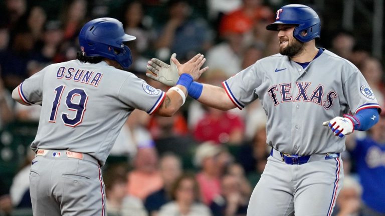 Texas Rangers' Jake Burger, right, celebrates with Alejandro Osuna after hitting a two-run home run against the Houston Astros during the fifth inning of a baseball game, Sunday, May 17, 2026, in Houston. (Eric Christian Smith/AP)