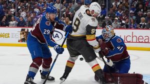 Vegas Golden Knights center Jack Eichel, centre, drives past Colorado Avalanche centre Nathan MacKinnon, left, to have his shot blocked by goaltender Scott Wedgewood during the second period in Game 2 of the Western Conference finals NHL hockey Stanley Cup playoff series Friday, May 22, 2026, in Denver. (David Zalubowski/AP)