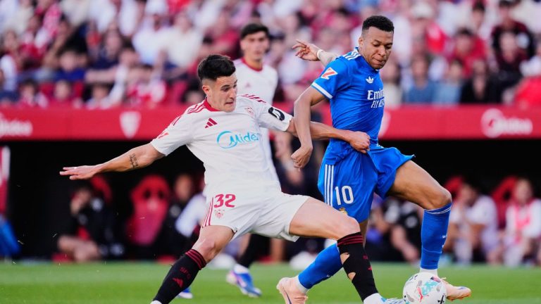 Real Madrid's Kylian Mbappe, right, duels for the ball with Sevilla's Andres Castrin during the Spanish La Liga soccer match in Seville, Spain, Sunday, May 17, 2026. (Jose Breton/AP)