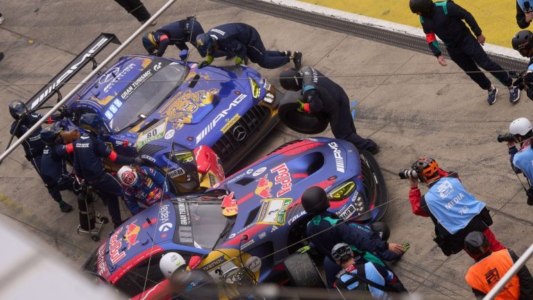 The pit crew works on the leading Max Verstappen's Mercedes AMG GT3 car, right, as it completes a pit stop at the same time as the second-placed Mercedes-AMG Team RAVENOL with Germany's Maro Engel, Germany's Luca Stolz, Germany's Fabian Schiller and Germany's Maxime Martin, during the Nurburgring 24-hour auto race in Nurburg, Germany, Sunday, May 17, 2026. (Thomas Frey/AP)