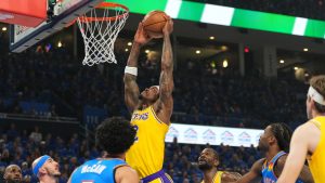 Los Angeles Lakers forward Jarred Vanderbilt, centre, goes up for a shot as Oklahoma City Thunder's Jared McCain (3) and Alex Caruso, second from left, defend in the first half of Game 1 in a second-round NBA basketball playoffs series Tuesday, May 5, 2026 in Oklahoma City. (Kyle Phillips/AP)