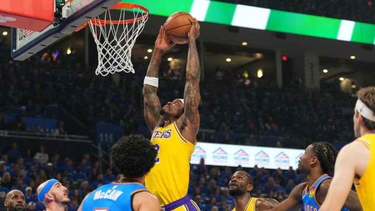 Los Angeles Lakers forward Jarred Vanderbilt, centre, goes up for a shot as Oklahoma City Thunder's Jared McCain (3) and Alex Caruso, second from left, defend in the first half of Game 1 in a second-round NBA basketball playoffs series Tuesday, May 5, 2026 in Oklahoma City. (Kyle Phillips/AP)