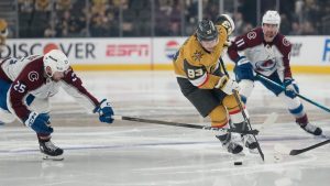 Vegas Golden Knights right wing Mitch Marner (93) skates with the puck as Colorado Avalanche right wing Logan O'Connor (25) defends during the second period in Game 4 of the Western Conference finals NHL hockey Stanley Cup playoff series Tuesday, May 26, 2026, in Las Vegas. (John Locher/AP)