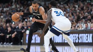 San Antonio Spurs forward Victor Wembanyama (1) drives against Minnesota Timberwolves forward Julius Randle (30) during the first half of Game 5 of an NBA basketball second-round playoffs series in Minneapolis, Tuesday, May 12, 2026. (Eric Gay/AP)