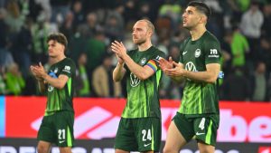 Wolfsburg's Christian Eriksen applauds after a Bundesliga first leg relegation soccer match between VfL Wolfsburg and SC Paderborn 07, Thursday, May 21, 2026, in Wolfsburg, Germany. (Swen Pförtner/dpa via AP)