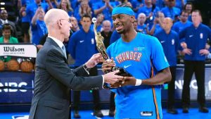 NBA Commissioner Adam Silver, left, presents Oklahoma City Thunder guard Shai Gilgeous-Alexander with the NBA MVP trophy before Game 1 in a third-round NBA basketball playoffs series against the San Antonio Spurs Monday, May 18, 2026, in Oklahoma City. (Tony Gutierrez/AP)