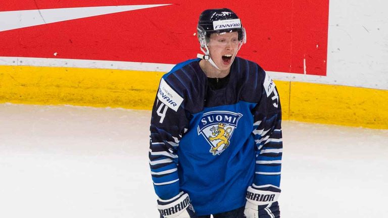Sweden's Emil Andrae (4) is checked to the ice as Finland's Aku Raty (34) reacts to an interference call during second period IIHF World Junior Hockey Championship action. (Jason Franson/THE CANADIAN PRESS)
