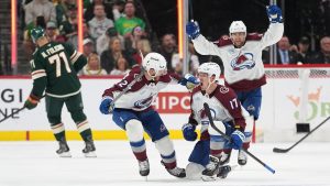 Colorado Avalanche centre Parker Kelly (17), middle, celebrates with Brett Kulak (27) after scoring a goal during the third period of Game 4 in an NHL Stanley Cup hockey second-round playoff series against the Minnesota Wild Monday, May 11, 2026, in St. Paul, Minn. (Abbie Parr/AP)