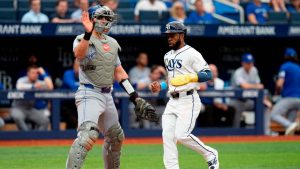 Tampa Bay Rays' Cedric Mullins, right, scores in front of Toronto Blue Jays catcher Tyler Heineman on a fielder's choice by Jonny DeLuca and an error by Toronto Blue Jays second baseman Ernie Clement during the eighth inning of a baseball game. (Chris O'Meara/AP)