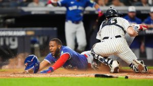Toronto Blue Jays Vladimir Guerrero Jr. dives into home plate to score against the New York Yankees during the third inning of Game 3 of baseball's American League Division Series, Tuesday, Oct. 7, 2025, in New York. (Frank Franklin II/AP)