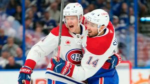 Montreal Canadiens centre Nick Suzuki (14) celebrates his goal against the Tampa Bay Lightning with defenceman Kaiden Guhle (21) during the first period in Game 7 of an NHL hockey Stanley Cup first-round playoff series, Sunday, May 3, 2026, in Tampa, Fla. (Chris O'Meara/AP)