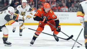 Anaheim Ducks' Leo Carlsson (91) brings the puck across the blue line against Vegas Golden Knights' Pavel Dorofeyev (16) during the first period of an NHL hockey game, Sunday, May 10, 2026, in Anaheim, Calif. (Scott Strazzante/AP Photo)