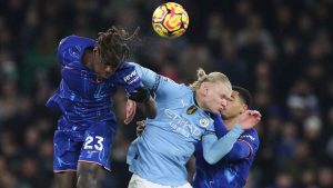 Manchester City's Erling Haaland, center, duels for the ball with Chelsea's Trevoh Chalobah, left, and Chelsea's Levi Colwill during the English Premier League soccer match. (Scott Heppell/AP)