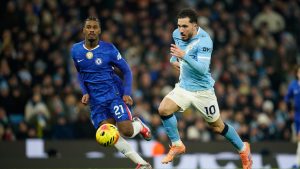 Manchester United's Matheus Cunha, right, and Chelsea's Jorrel Hato go for the ball during the English Premier League soccer match between Manchester City and Chelsea in Manchester, England, Sunday, Jan. 4, 2026. (Dave Thompson/AP)