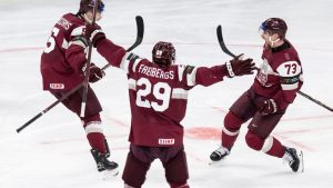 Latvia's Deniss Smirnovs, right, celebrates after scoring his side's second goal during the 2026 IIHF Men's Ice Hockey World Championship preliminary round group A match between Latvia and the United States in Zurich, Switzerland, Saturday, May 23, 2026. (Andreas Becker/Keystone via AP)