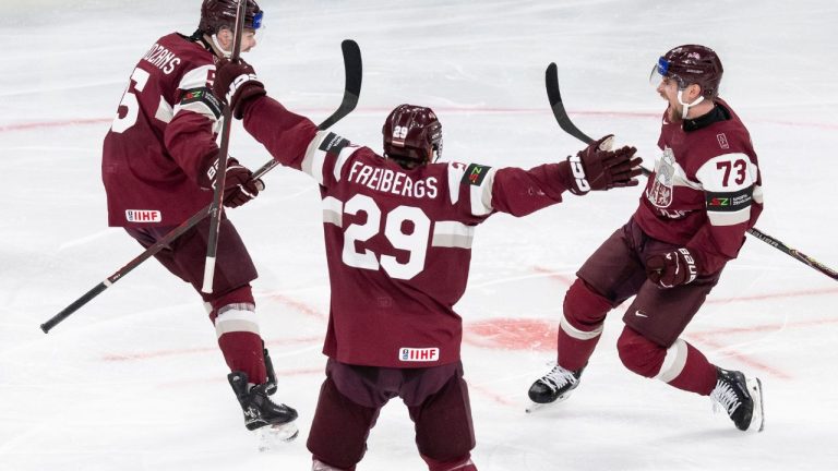 Latvia's Deniss Smirnovs, right, celebrates after scoring his side's second goal during the 2026 IIHF Men's Ice Hockey World Championship preliminary round group A match between Latvia and the United States in Zurich, Switzerland, Saturday, May 23, 2026. (Andreas Becker/Keystone via AP)