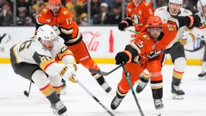 Vegas Golden Knights right wing Alexander Holtz, left, and Anaheim Ducks center Ryan Poehling reach for the puck during the third period of an NHL hockey game Sunday, Feb. 1, 2026, in Anaheim, Calif. (Mark J. Terrill/AP)