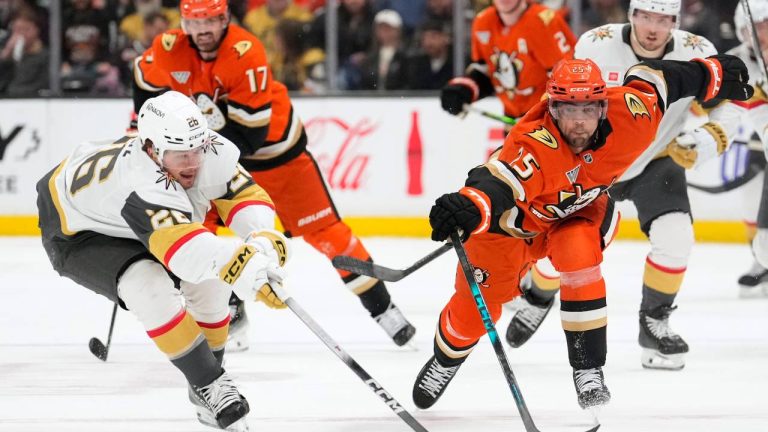 Vegas Golden Knights right wing Alexander Holtz, left, and Anaheim Ducks center Ryan Poehling reach for the puck during the third period of an NHL hockey game Sunday, Feb. 1, 2026, in Anaheim, Calif. (Mark J. Terrill/AP)