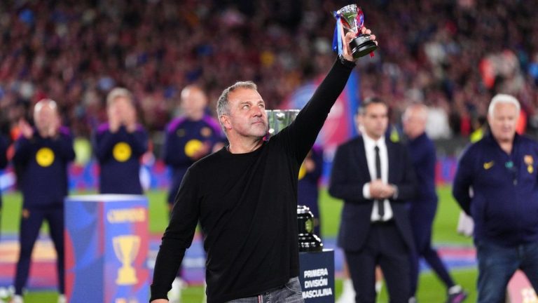 Barcelona head coach Hansi Flick lifts his award to the sky celebrating after defeating Real Madrid 2-0 to win the Spanish La Liga soccer championship with three rounds to spare, in Barcelona, Spain, Sunday, May 10, 2026. (Joan Mateu Parra/AP)