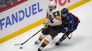 Vegas Golden Knights defenceman Rasmus Andersson, left, collects the puck as Colorado Avalanche center Parker Kelly, right, covers during the first period in Game 2 of the Western Conference finals NHL hockey Stanley Cup playoff series Friday, May 22, 2026, in Denver. (David Zalubowski/AP)
