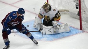 Vegas Golden Knights goaltender Carter Hart, right, stops a shot by Colorado Avalanche right wing Valeri Nichushkin during the third period in Game 1 of the Western Conference finals NHL hockey Stanley Cup playoff series Wednesday, May 20, 2026, in Denver. (David Zalubowski/AP Photo)