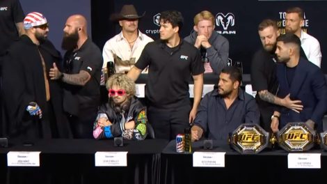 Josh-Hokit-and-Ilia-Topuria-yell-at-each-other-at-a-UFC-press-conference-while-being-separated-by-security.