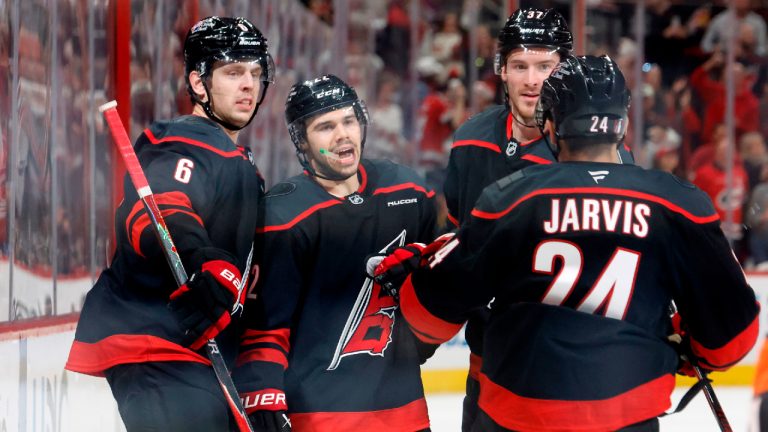 Carolina Hurricanes' Logan Stankoven, centre, celebrates his goal with teammates Mike Reilly (6), Andrei Svechnikov, (37) and Seth Jarvis (24) during the second period of Game 1 of an NHL hockey Stanley Cup second-round playoff series against the Philadelphia Flyers in Raleigh, N.C., Saturday, May 2, 2026. (Karl DeBlaker/AP)