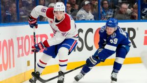 Montreal Canadiens defenceman Lane Hutson (48) controls the puck against Tampa Bay Lightning centre Jake Guentzel (59) during the second period in Game 5 of an NHL hockey Stanley Cup first-round playoff series, Wednesday, April 29, 2026, in Tampa, Fla. (Chris O'Meara/AP)