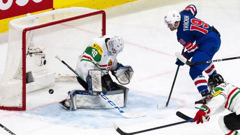 Matthew Tkachuk of the U.S., right, scores against Hungary's goaltender Adam Vay during the 2026 IIHF Men's Ice Hockey World Championship preliminary round group A game between United States and Hungary, in Zurich, Switzerland, Monday, May 25, 2026. (Andreas Becker/Keystone via AP)