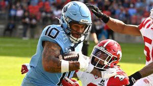 Toronto Argos wide receiver Kevin Mital (10) is tackled by Calgary Stampeders defensive back Damon Webb (9) during first half CFL football action in Toronto, Saturday, June 14, 2025. (Jon Blacker/THE CANADIAN PRESS)
