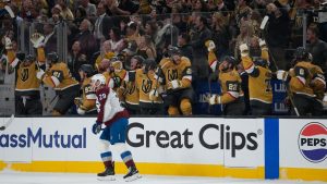 Vegas Golden Knights players celebrate as Colorado Avalanche center Nathan MacKinnon (29) skates by at the end of Game 4 of the Western Conference finals NHL hockey Stanley Cup playoff series Tuesday, May 26, 2026, in Las Vegas. (John Locher/AP)