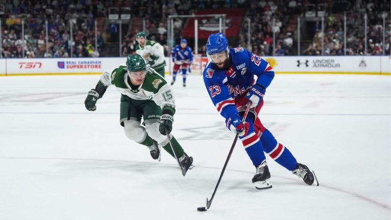 Kitchener Rangers' Sam O'Reilly (23) skates with the puck past Everett Silvertips' Jaxsin Vaughan (15) during the second period of the Memorial Cup final hockey game, in Kelowna, B.C., on Sunday, May 31, 2026. (Darryl Dyck/THE CANADIAN PRESS)