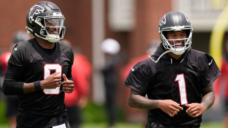 Atlanta Falcons quarterback's Michael Penix Jr. and Tua Tagovailoa (1) move during an NFL football practice, Wednesday, May 27, 2026, in Flowery Branch, Ga. (Mike Stewart/AP)