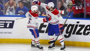 Montreal Canadiens defenceman Alexandre Carrier (45) celebrates his goal with centre Phillip Danault (24) during the third period in Game 2 of a second-round NHL hockey Stanley Cup playoff series against the Buffalo Sabres, Friday, May 8, 2026, in Buffalo, N.Y. (Jeffrey T. Barnes/AP)