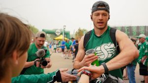 Saskatchewan Roughriders receiver Mitch Picton interacts with fans before a spring training scrimmage in Saskatoon, Sask., on Saturday, May 20, 2023. (Heywood Yu/THE CANADIAN PRESS)