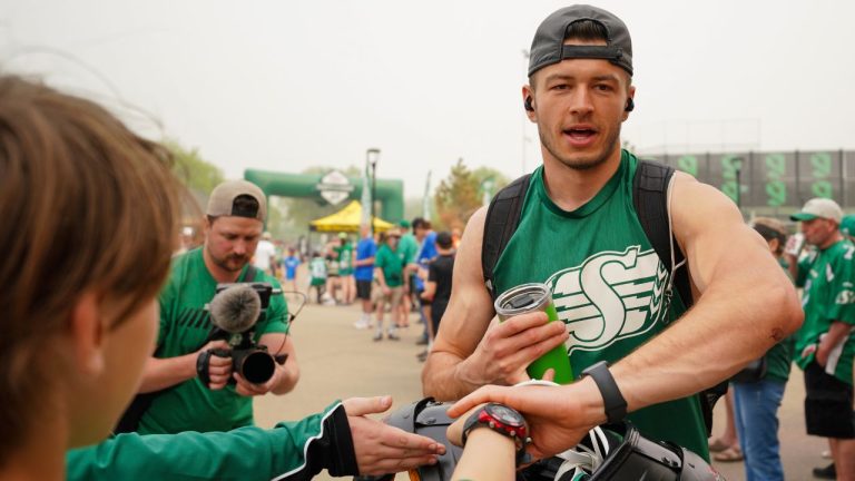 Saskatchewan Roughriders receiver Mitch Picton interacts with fans before a spring training scrimmage in Saskatoon, Sask., on Saturday, May 20, 2023. (Heywood Yu/THE CANADIAN PRESS)