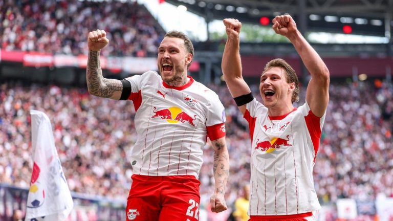 Leipzig's Willi Orban, right, celebrates with and David Raum after scoring, during the German Bundesliga soccer match between RB Leipzig and FC St. Pauli, in Leipzig, Germany, Saturday, May 9, 2026. (Jan Woitas/dpa via AP)