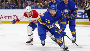 Buffalo Sabres right wing Jack Quinn (22) carries the puck past Montreal Canadiens right wing Cole Caufield (13) during the second period in Game 7 of a second-round NHL hockey Stanley Cup playoff series Monday, May 18, 2026, in Buffalo, N.Y. (Jeffrey T. Barnes/AP)