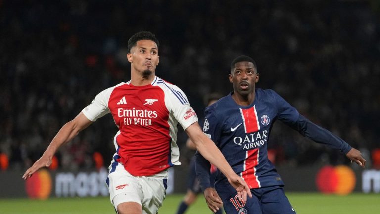 Arsenal's William Saliba, left, challenges PSG's goalkeeper PSG's Ousmane Dembele during the Champions League semifinal, second leg soccer match between Paris Saint-Germain and Arsenal at the Parc des Princes in Paris, Wednesday, May 7, 2025. (Thibault Camus/AP)