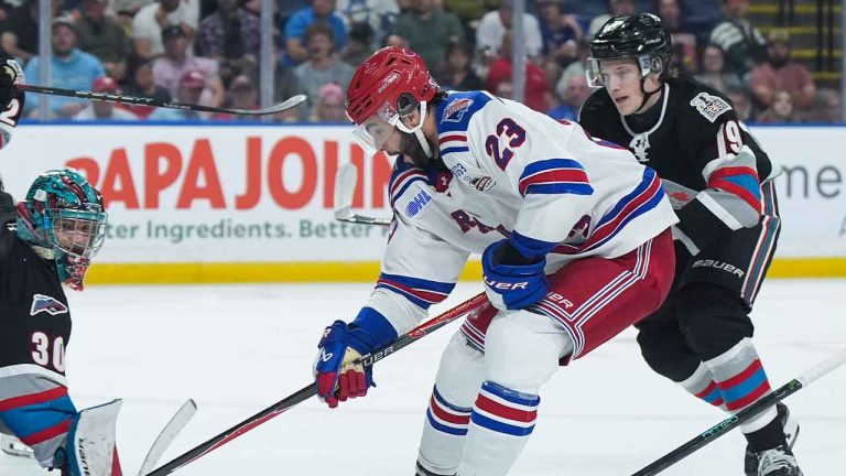 Kitchener Rangers' Sam O'Reilly (23) scores against Kelowna Rockets goalie Harrison Boettiger (30) during the third period of a Memorial Cup hockey game. (Darryl Dyck/THE CANADIAN PRESS)