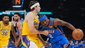 Oklahoma City Thunder guard Shai Gilgeous-Alexander (2) drives to the basket as Los Angeles Lakers' Austin Reaves, left, defends in the second half of Game 1 in a second-round NBA basketball playoffs series Tuesday, May 5, 2026 in Oklahoma City. (Kyle Phillips/AP Photo)