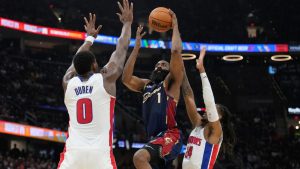 Cleveland Cavaliers' James Harden (1) shoots between Detroit Pistons' Jalen Duren (0) and Daniss Jenkins (24) in the second half of Game 6 of a second-round NBA basketball playoffs series Friday, May 15, 2026, in Cleveland. (Sue Ogrocki/AP)