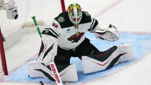 Minnesota Wild goaltender Jesper Wallstedt makes a stick-save in the first period of Game 1 of an NHL hockey Stanley Cup second-round playoff series against the Colorado Avalanche, Sunday, May 3, 2026, in Denver. (David Zalubowski/AP)