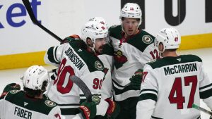 Minnesota Wild left wing Marcus Johansson, left, is congratulated after scoring a goal by defenceman Quinn Hughes, second from left, left wing Matt Boldy and centre Michael McCarron in the first period of Game 5 of an Stanley Cup second-round playoff series against the Colorado Avalanche Wednesday, May 13, 2026, in Denver. (David Zalubowski/AP Photo)