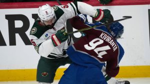Minnesota Wild defenceman Jake Middleton, left, checks Colorado Avalanche left wing Joel Kiviranta in the first period of Game 5 of an NHL Stanley Cup hockey second-round playoff series, Wednesday, May 13, 2026, in Denver. (David Zalubowski/AP Photo)