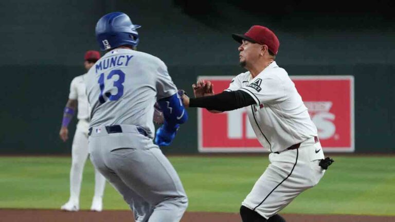 Los Angeles Dodgers' Max Muncy (13) and Arizona Diamondbacks first baseman Ildemaro Vargas, right, collide on a play in the fifth inning of a baseball game, Thursday, June 4, 2026, in Phoenix. (Rick Scuteri/AP)