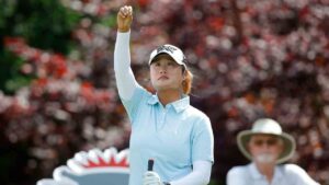 Gina Kim watches as she drops grass to check the wind before her tee shot on the 17th hole during the first round of the Dow Championship LPGA golf tournament, Thursday, June 11, 2026, at Midland Country Club in Midland, Mich. (Al Goldis/AP)