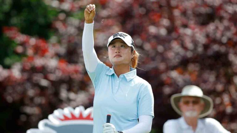 Gina Kim watches as she drops grass to check the wind before her tee shot on the 17th hole during the first round of the Dow Championship LPGA golf tournament, Thursday, June 11, 2026, at Midland Country Club in Midland, Mich. (Al Goldis/AP)