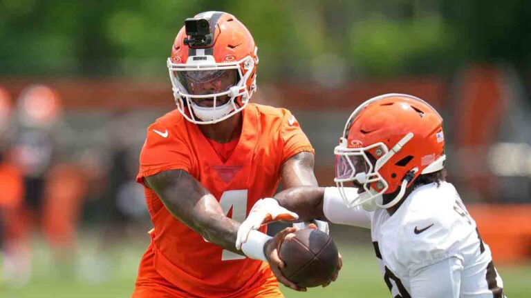 Cleveland Browns quarterback Deshaun Watson, left, hands off to running back Dylan Sampson, right, during the teams' NFL football practice, Wednesday, June 10, 2026, in Berea, Ohio. (Sue Ogrocki/AP)